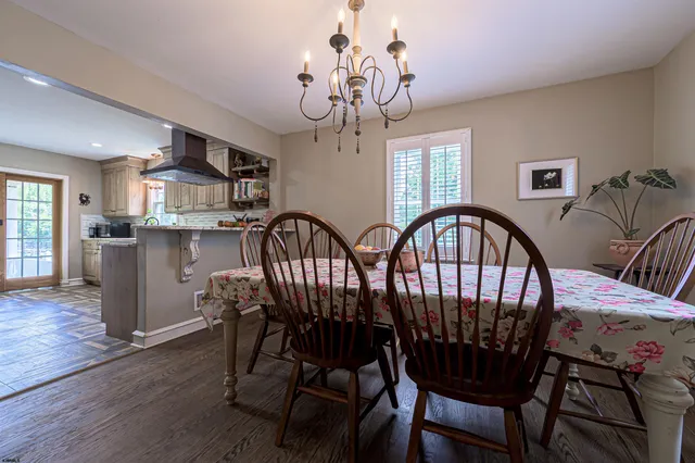 a view of a dining room with furniture wooden floor and chandelier