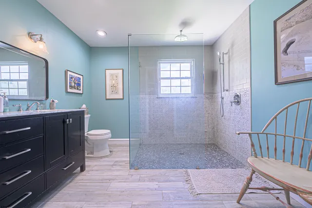 a bathroom with a sink a toilet and shower