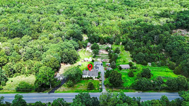 an aerial view of a house with lots of trees