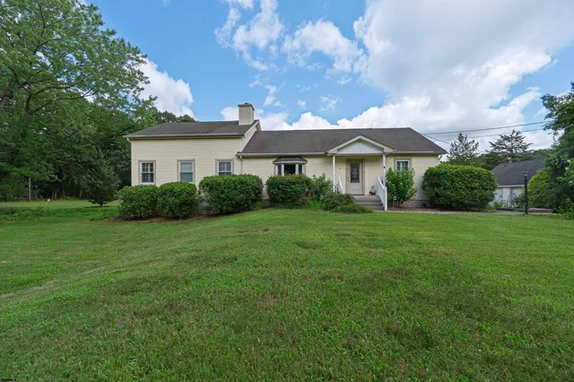 a view of a house with a yard and plants