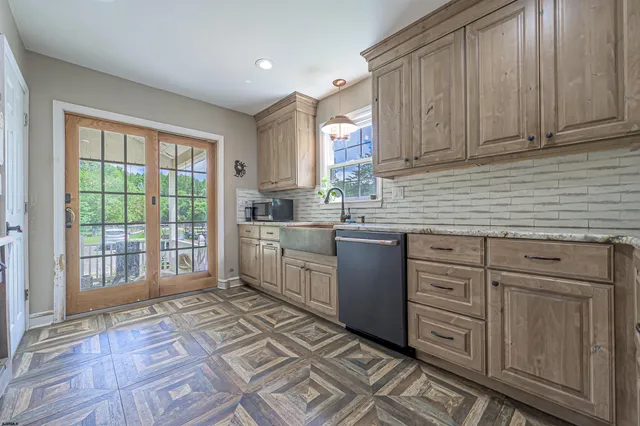 a kitchen with sink cabinets and window
