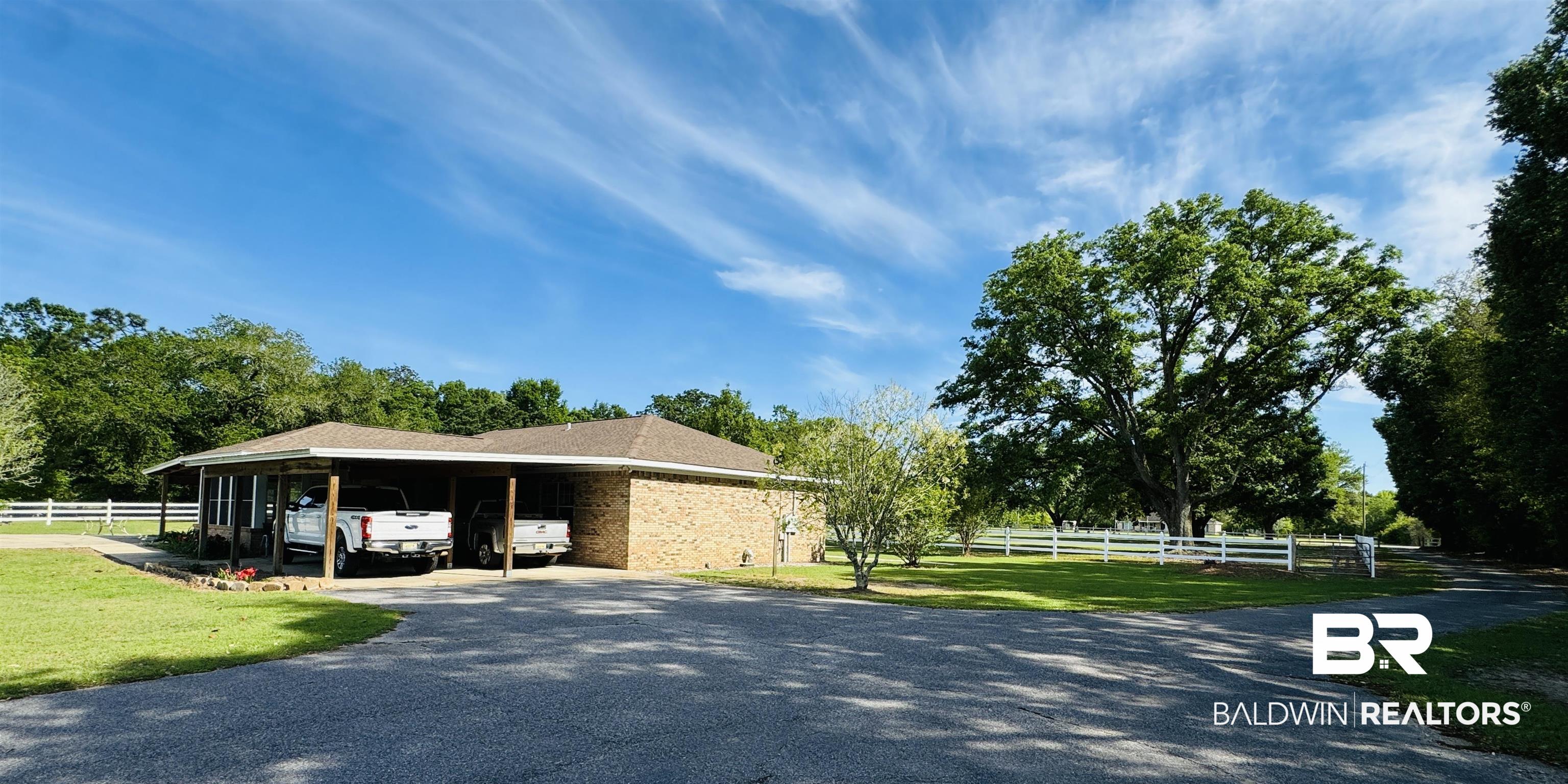 13795 White Road Silverhill, AL 36576 - Photo 85 of 99 View of side of home with driveway, brick siding, and a carport
