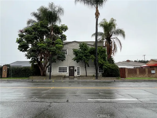 a house with palm tree in front of it