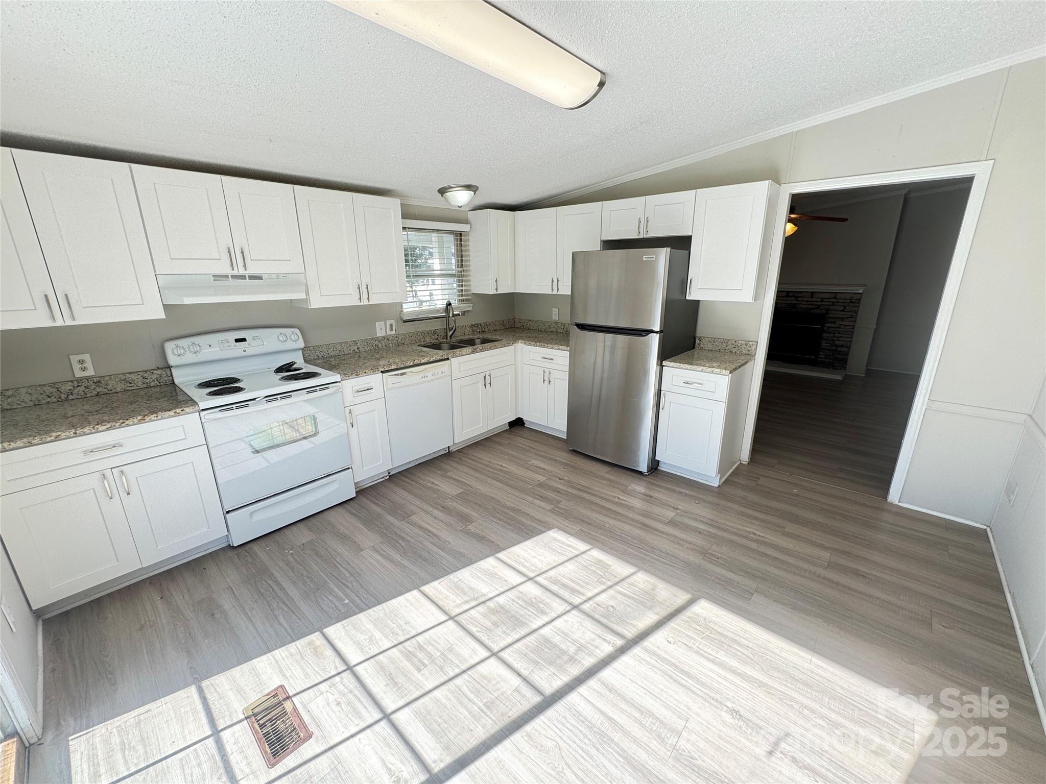 406 West Mill Street Landis, NC 28088 - Photo 11 of 20 a kitchen with white cabinets and white appliances