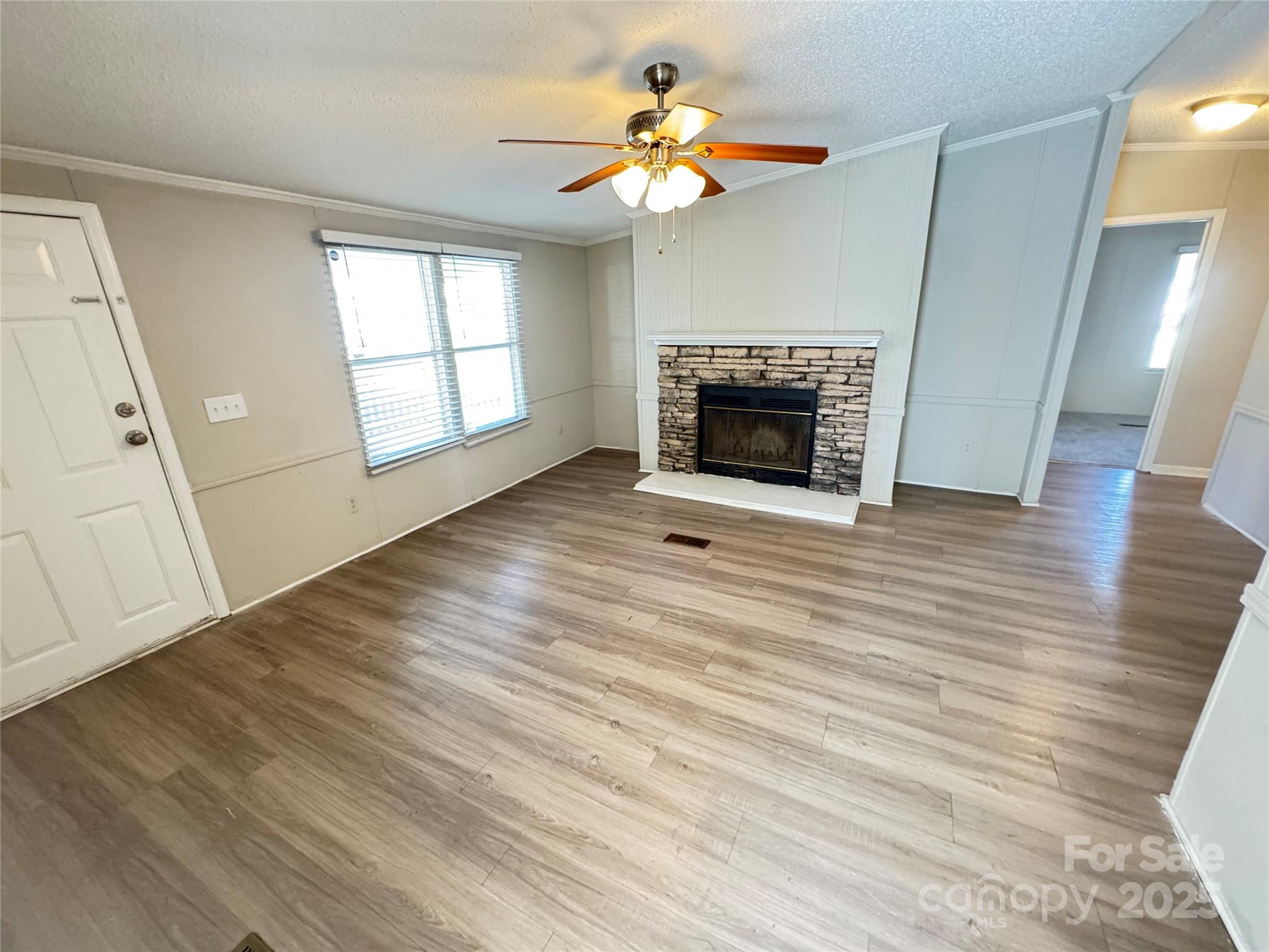 406 West Mill Street Landis, NC 28088 - Photo 12 of 20 a view of an empty room with a fireplace and a window