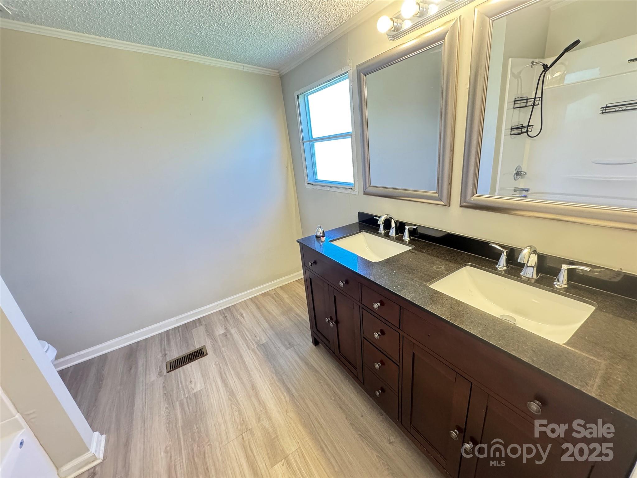 406 West Mill Street Landis, NC 28088 - Photo 14 of 20 a bathroom with a double vanity sink and mirror