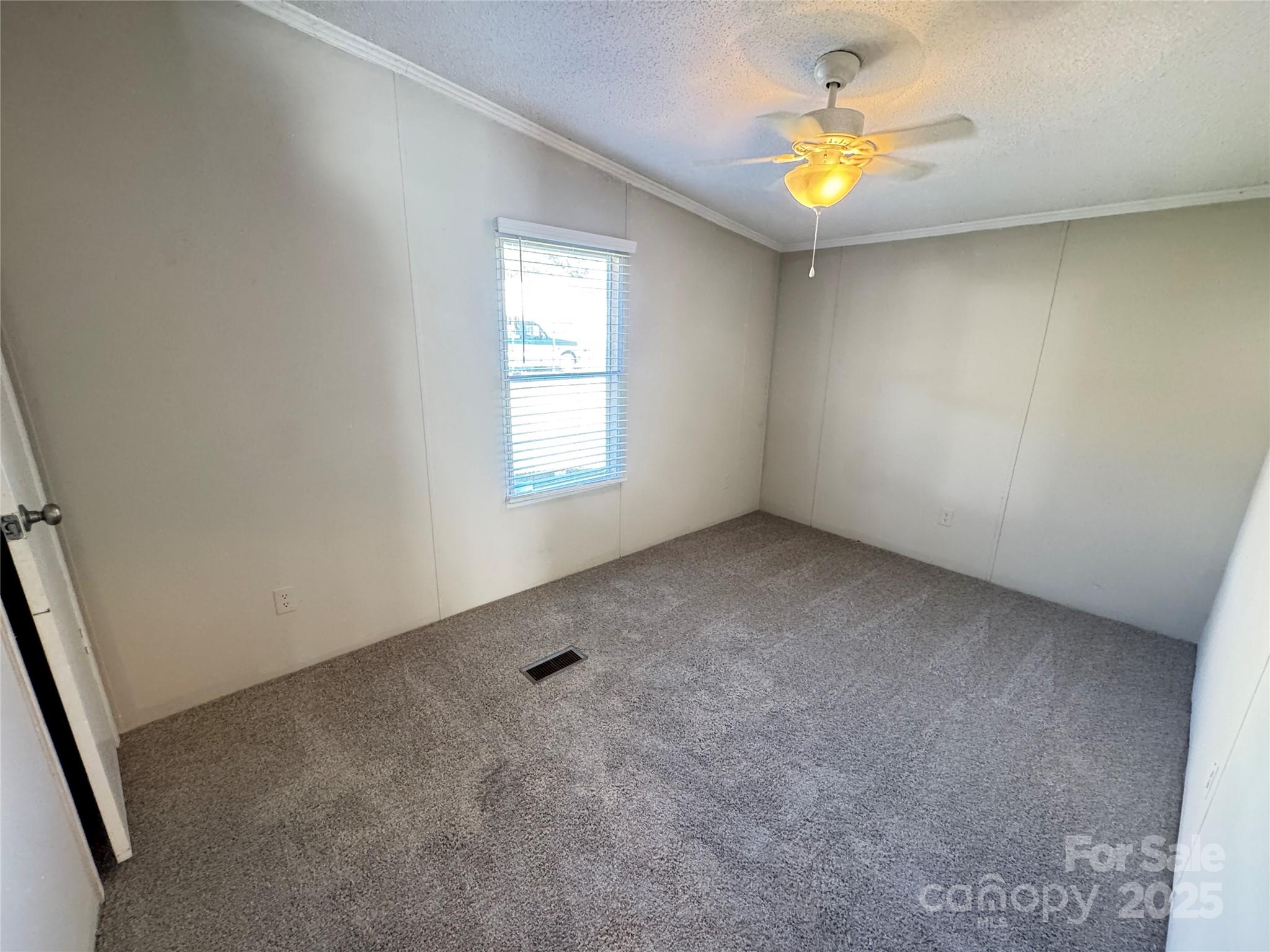 406 West Mill Street Landis, NC 28088 - Photo 18 of 20 an empty room with a window and a ceiling fan