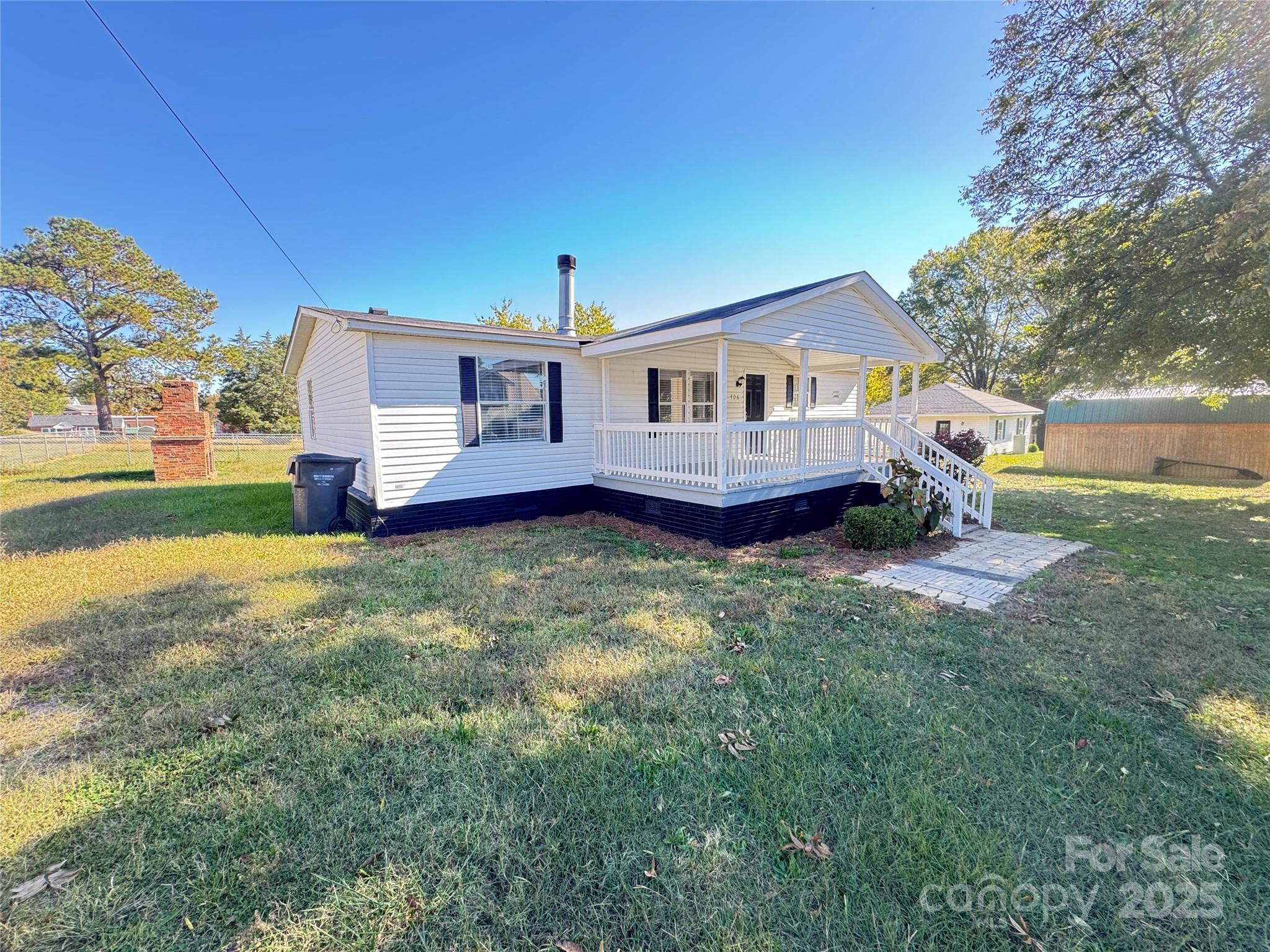 406 West Mill Street Landis, NC 28088 - Photo 4 of 20 a front view of a house with a garden and plants