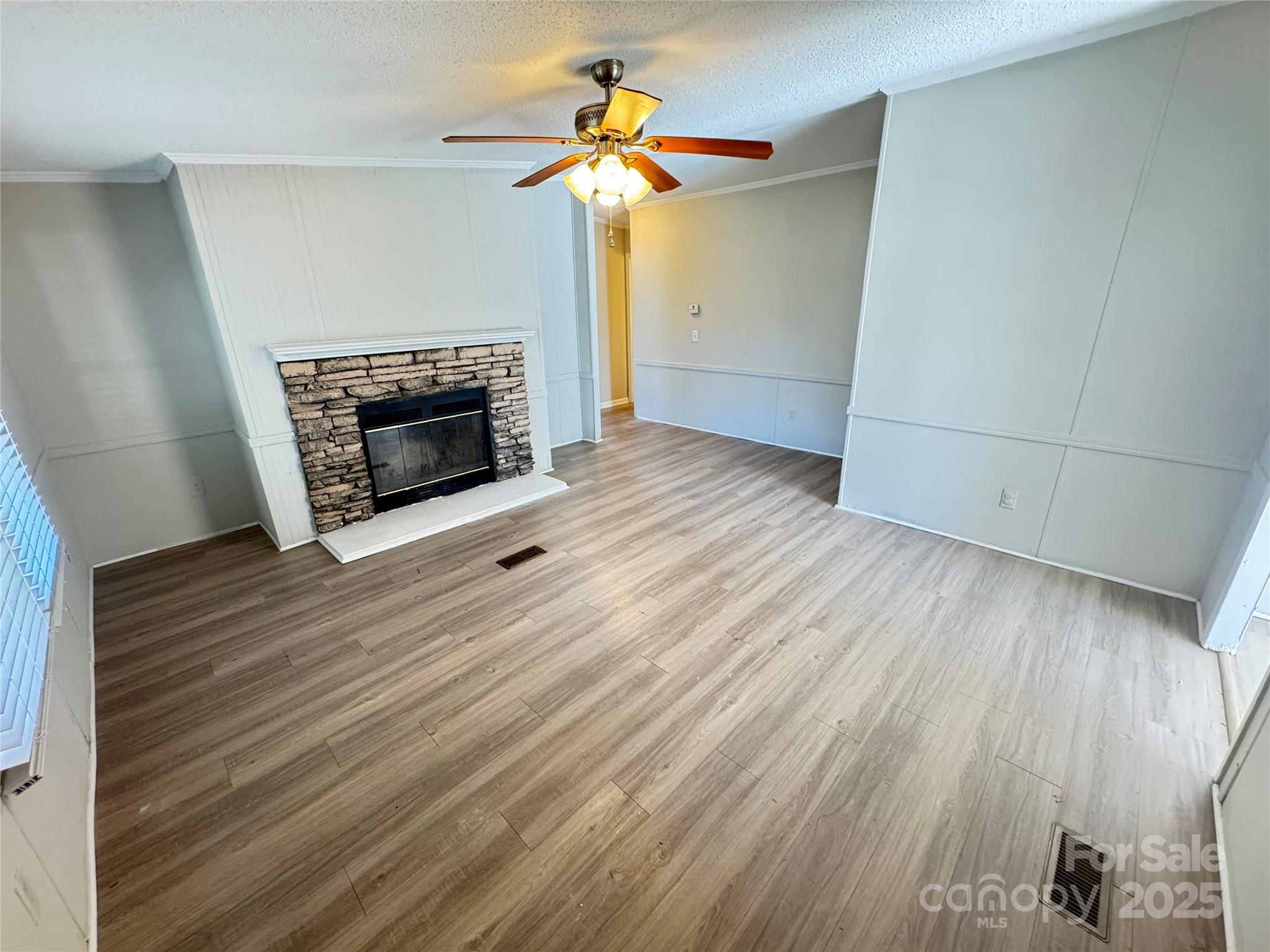 406 West Mill Street Landis, NC 28088 - Photo 5 of 20 wooden floor in an empty room with a fireplace
