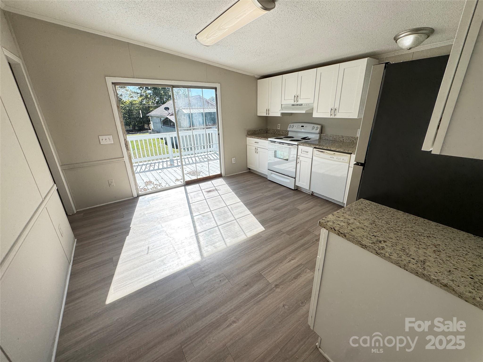 406 West Mill Street Landis, NC 28088 - Photo 7 of 20 a kitchen with granite countertop a stove a sink and a refrigerator