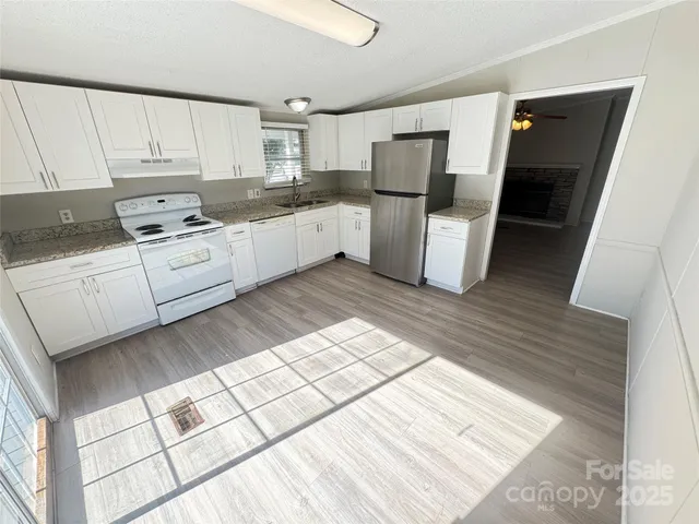 a kitchen with white cabinets and white appliances