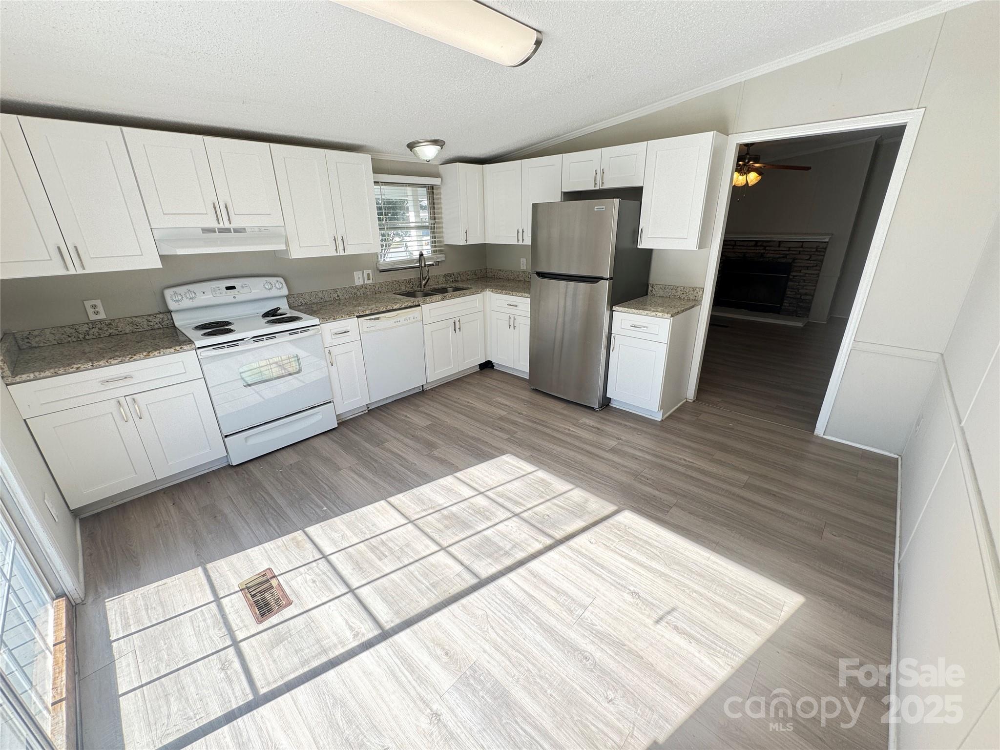 406 West Mill Street Landis, NC 28088 - Photo 8 of 20 a kitchen with white cabinets and white appliances