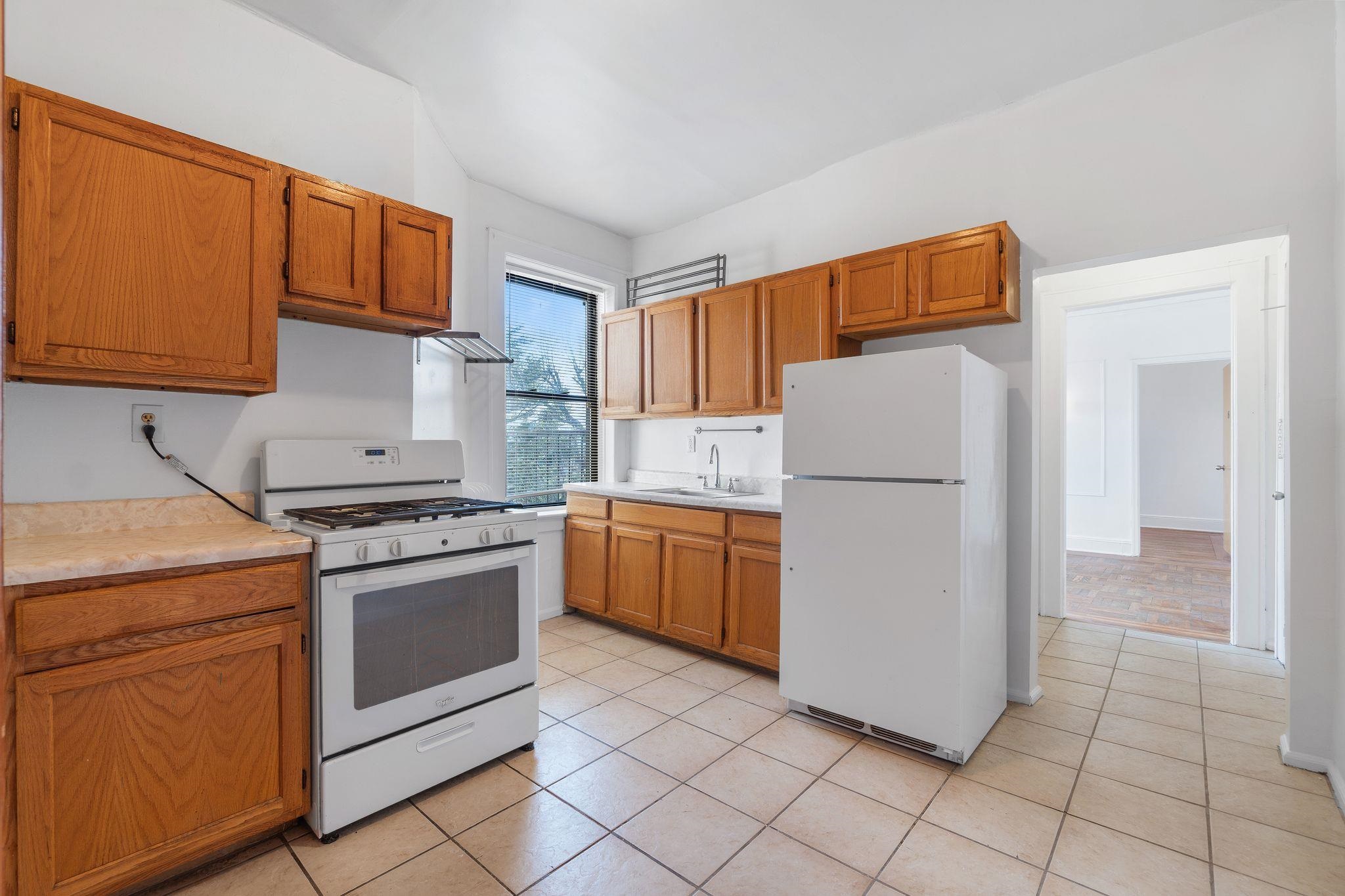 435 79th Street, Unit 47 North Bergen, NJ 07047 - Photo 13 of 20 a kitchen with a refrigerator sink stove and cabinets