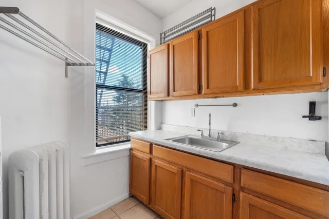 a kitchen with stainless steel appliances granite countertop a sink a refrigerator and cabinets