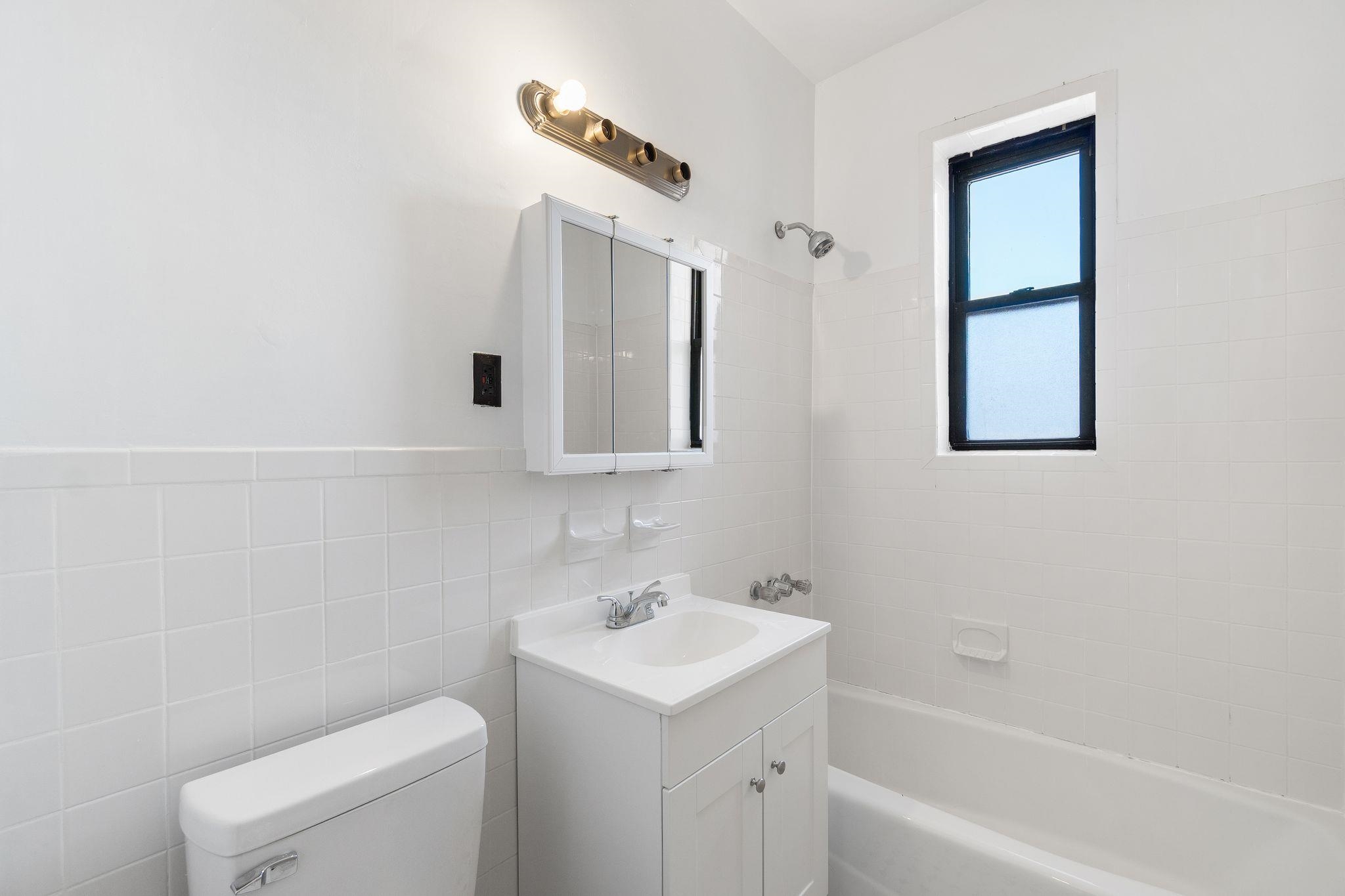 435 79th Street, Unit 47 North Bergen, NJ 07047 - Photo 15 of 20 a bathroom with a toilet sink and mirror
