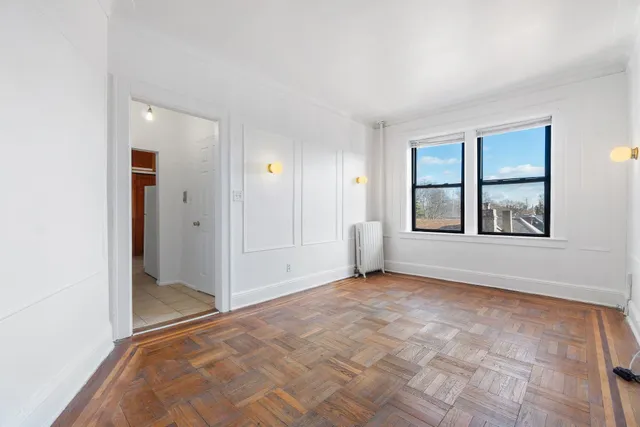 an empty room with windows and closet