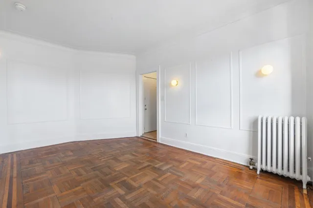 a view of an empty room and wooden floor