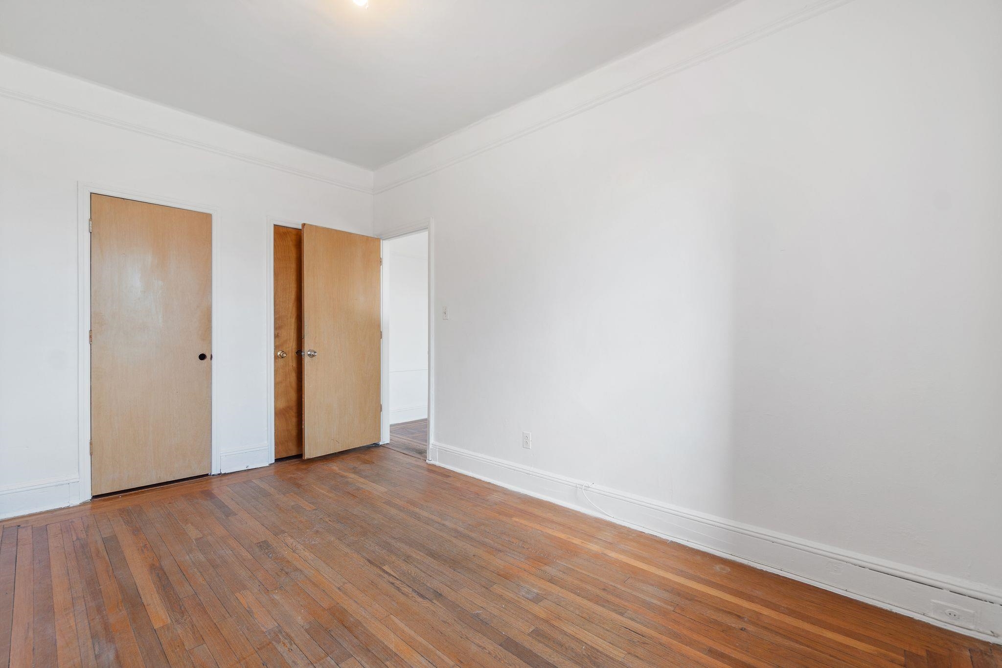 435 79th Street, Unit 47 North Bergen, NJ 07047 - Photo 5 of 20 a view of an empty room with wooden floor