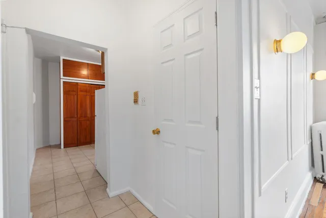 a view of a room with wooden floor and bathroom