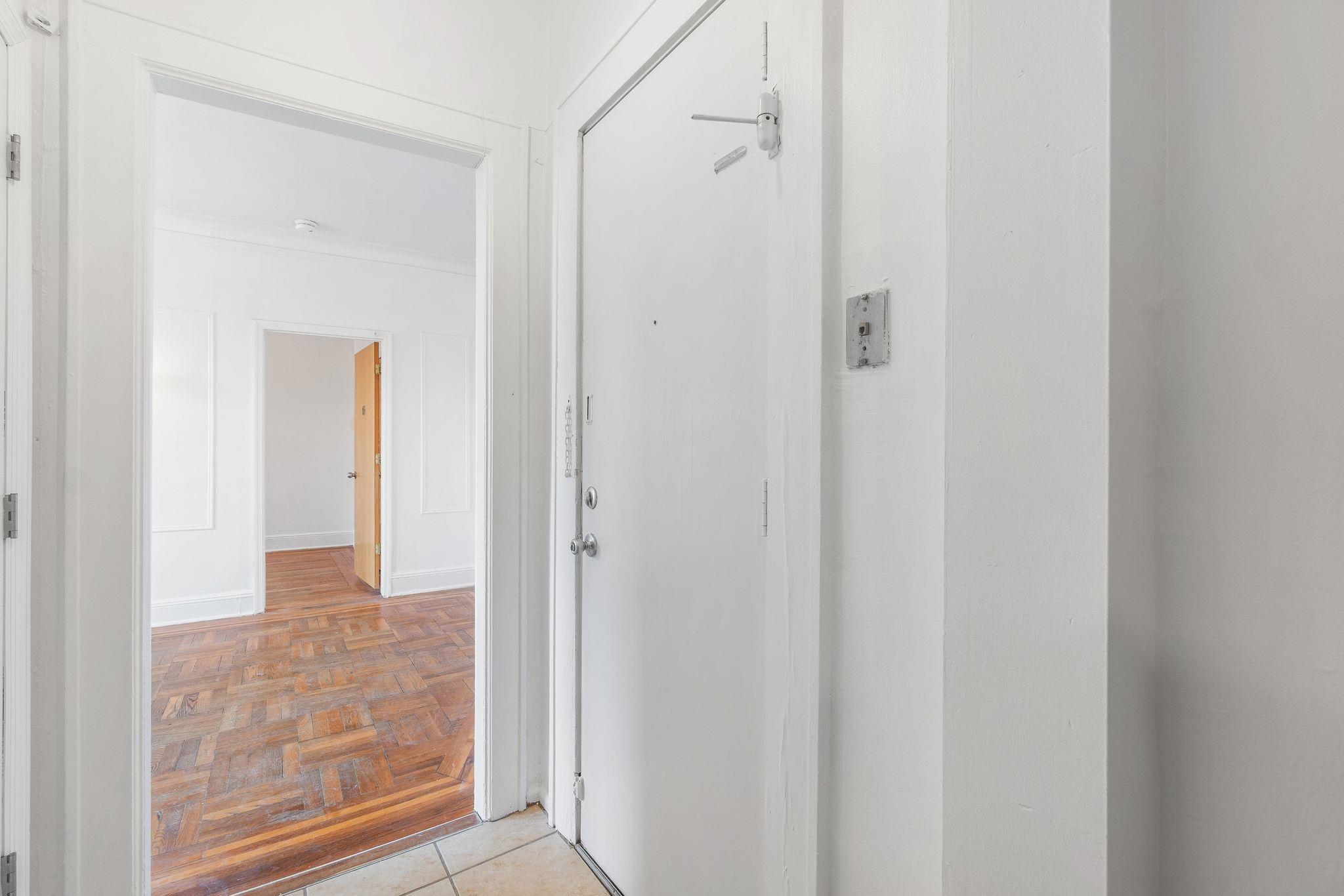 435 79th Street, Unit 47 North Bergen, NJ 07047 - Photo 9 of 20 a view of a hallway with wooden floor and a bathroom