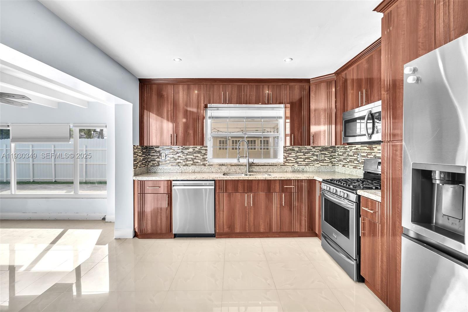 8300 Northwest 201st Street Hialeah, FL 33015 - Photo 13 of 33 a kitchen with stainless steel appliances granite countertop a stove a sink and a refrigerator