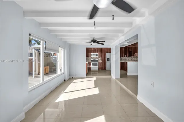 a view of a hallway with a window and a kitchen