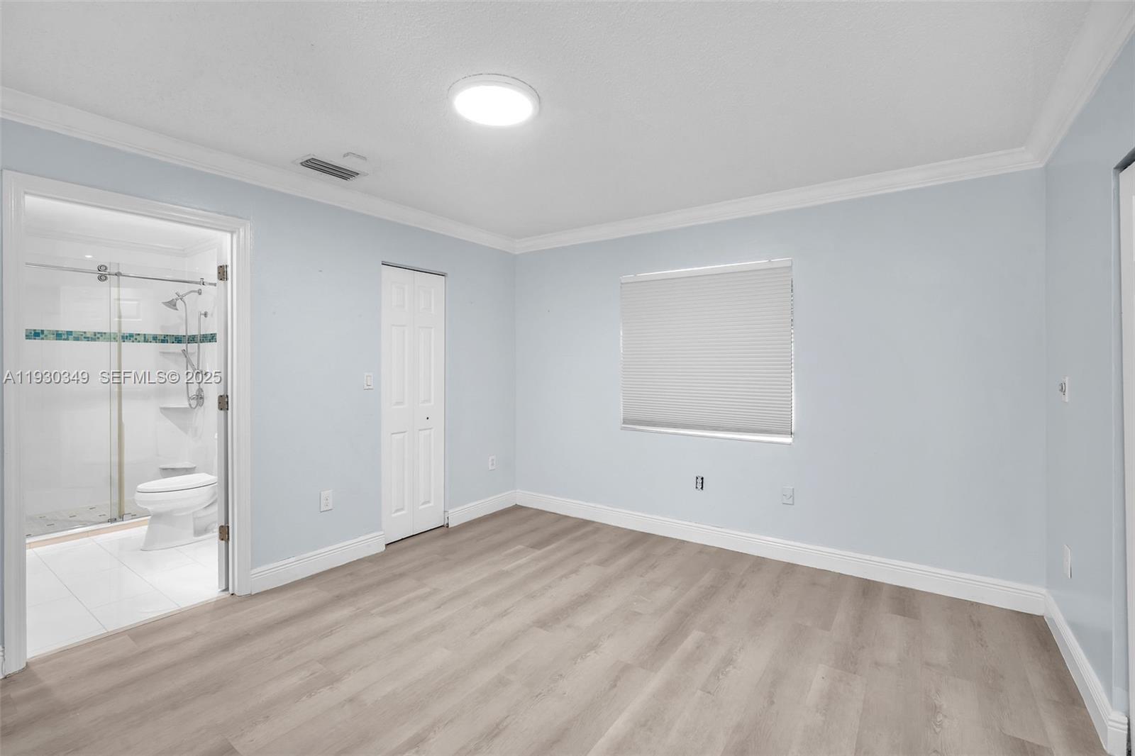 8300 Northwest 201st Street Hialeah, FL 33015 - Photo 17 of 33 an empty room with wooden floor and windows