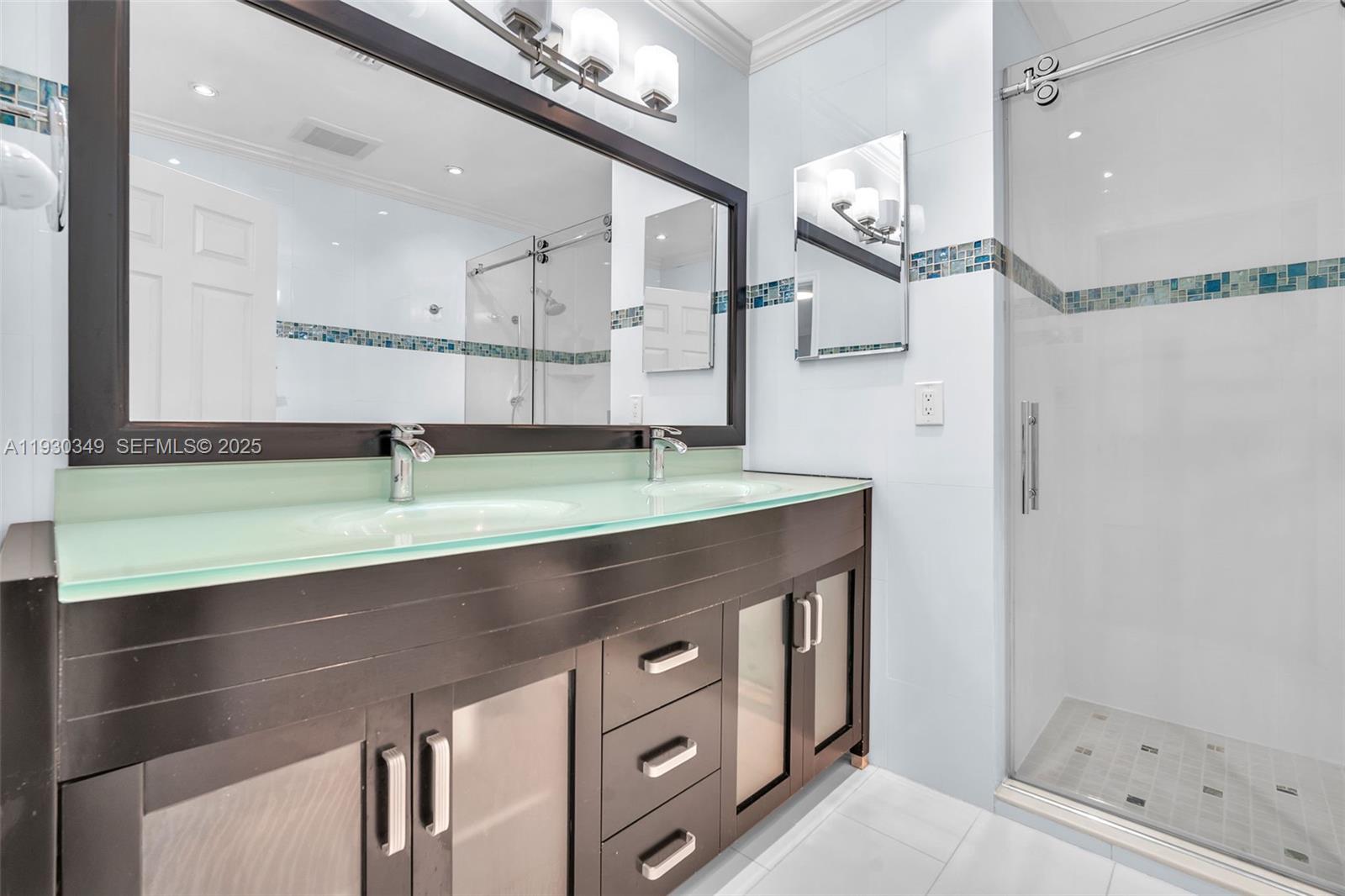 8300 Northwest 201st Street Hialeah, FL 33015 - Photo 19 of 33 a bathroom with a sink a mirror and a shower