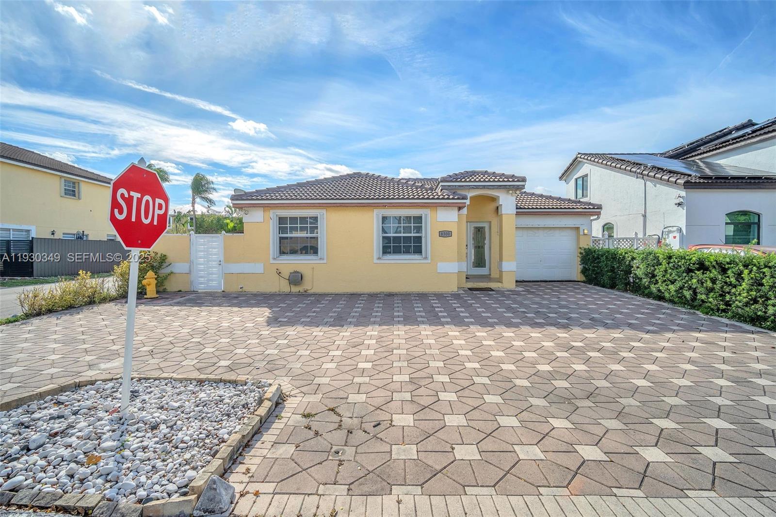 8300 Northwest 201st Street Hialeah, FL 33015 - Photo 2 of 33 a front view of a house with a yard
