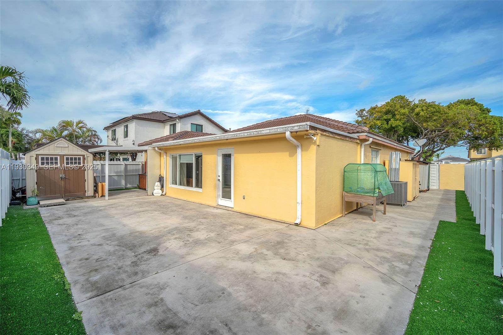 8300 Northwest 201st Street Hialeah, FL 33015 - Photo 22 of 33 a view of a house with a yard and pathway