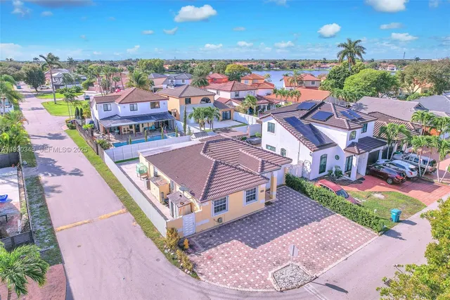 an aerial view of a house with a swimming pool yard and outdoor seating