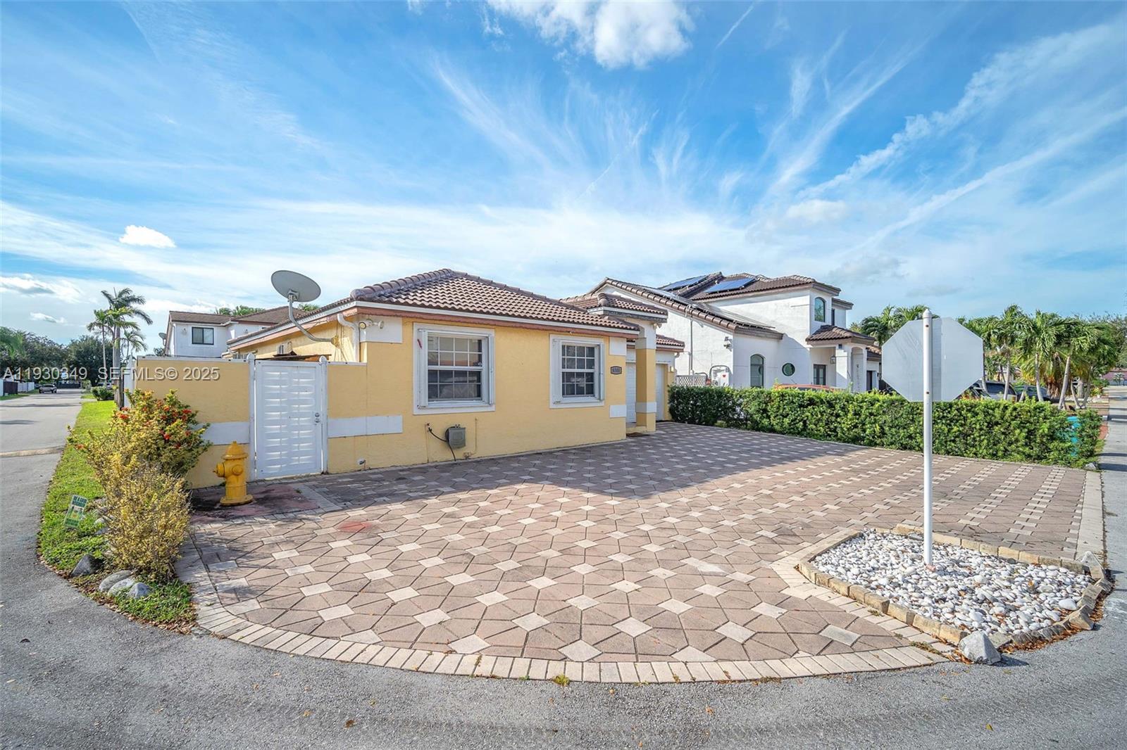 8300 Northwest 201st Street Hialeah, FL 33015 - Photo 3 of 33 a front view of a house with a yard