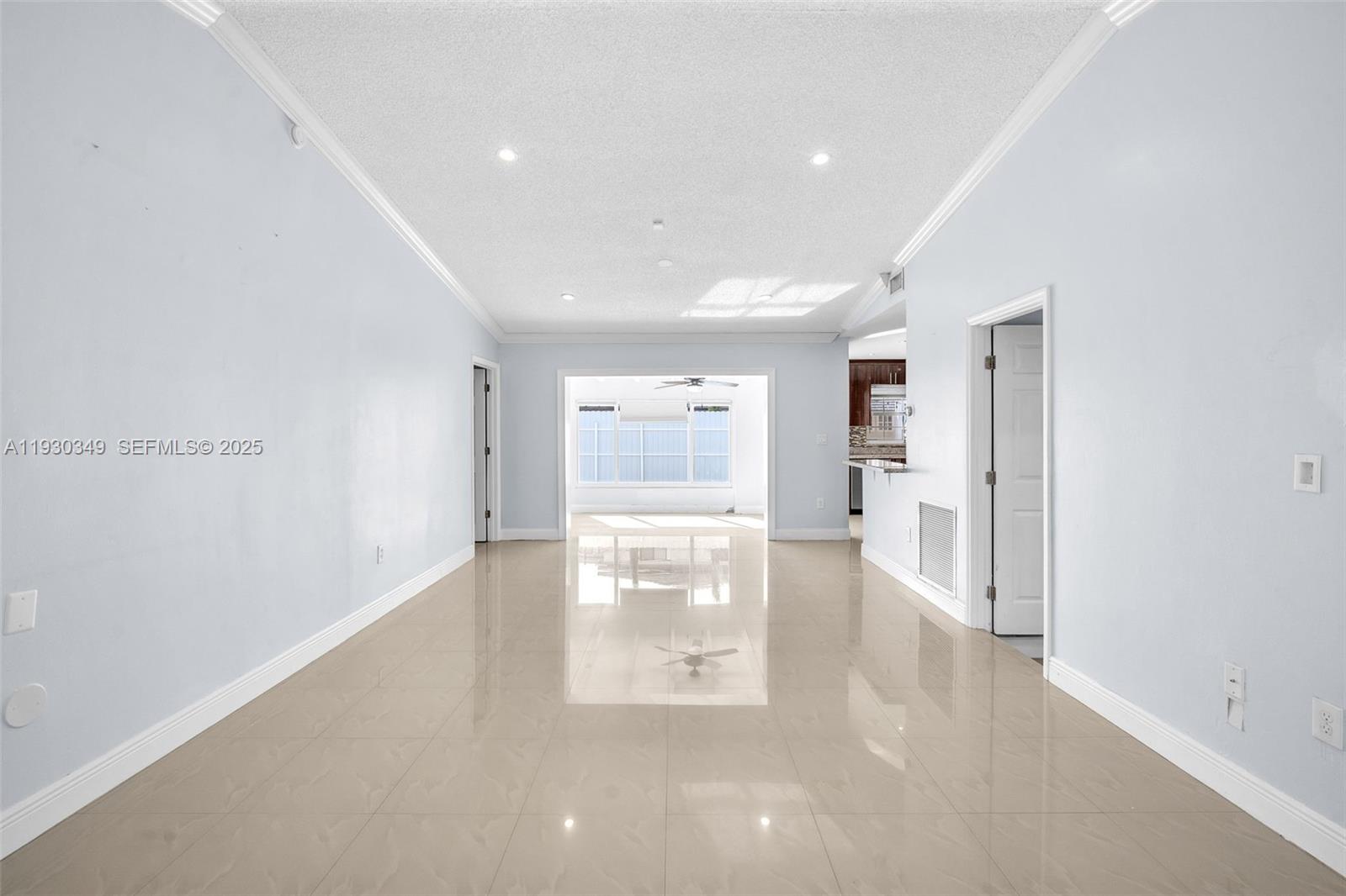 8300 Northwest 201st Street Hialeah, FL 33015 - Photo 4 of 33 a room with wooden floor and white walls