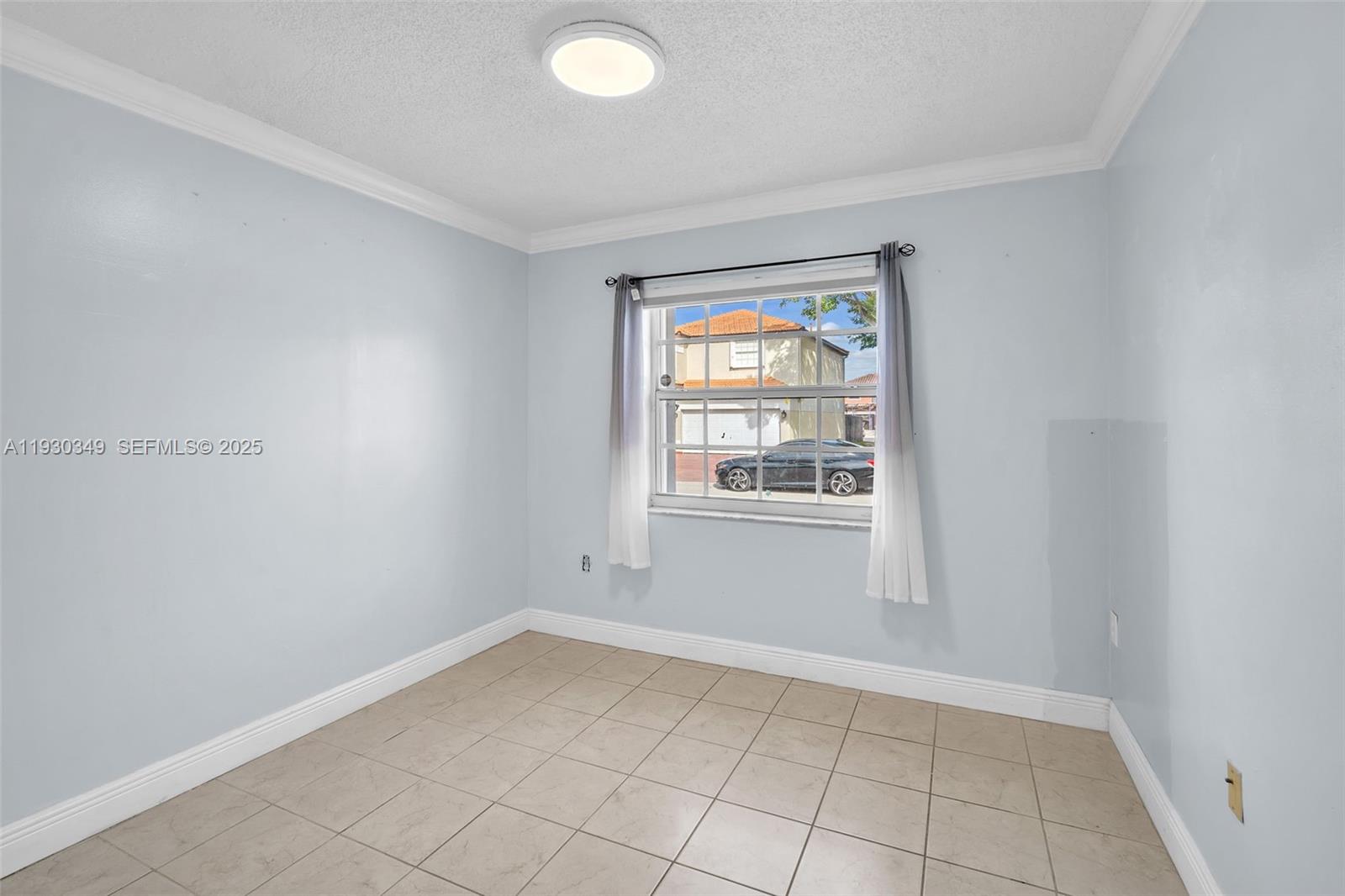 8300 Northwest 201st Street Hialeah, FL 33015 - Photo 7 of 33 a view of an empty room with a window