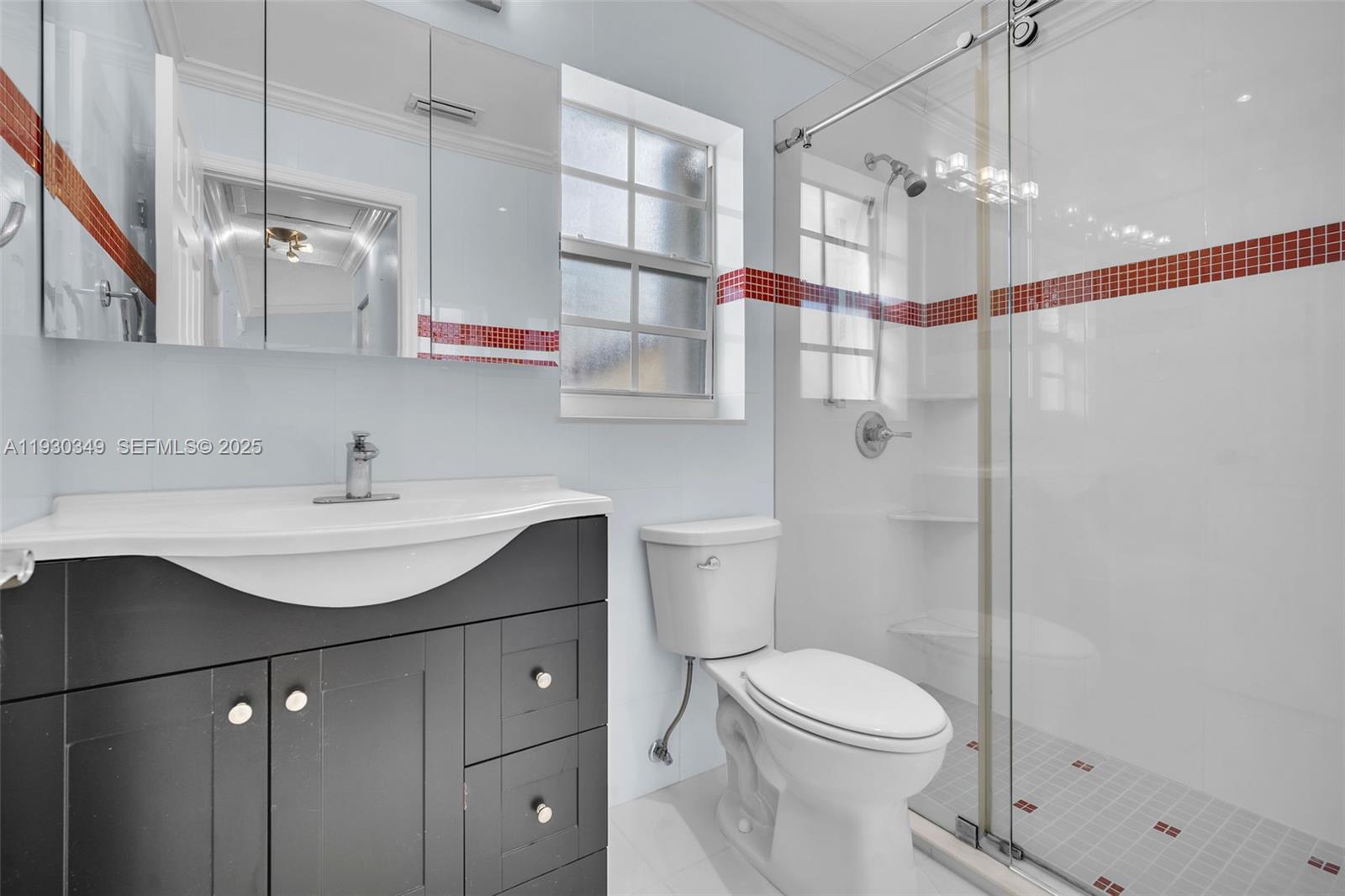 8300 Northwest 201st Street Hialeah, FL 33015 - Photo 9 of 33 a bathroom with a sink a toilet and shower