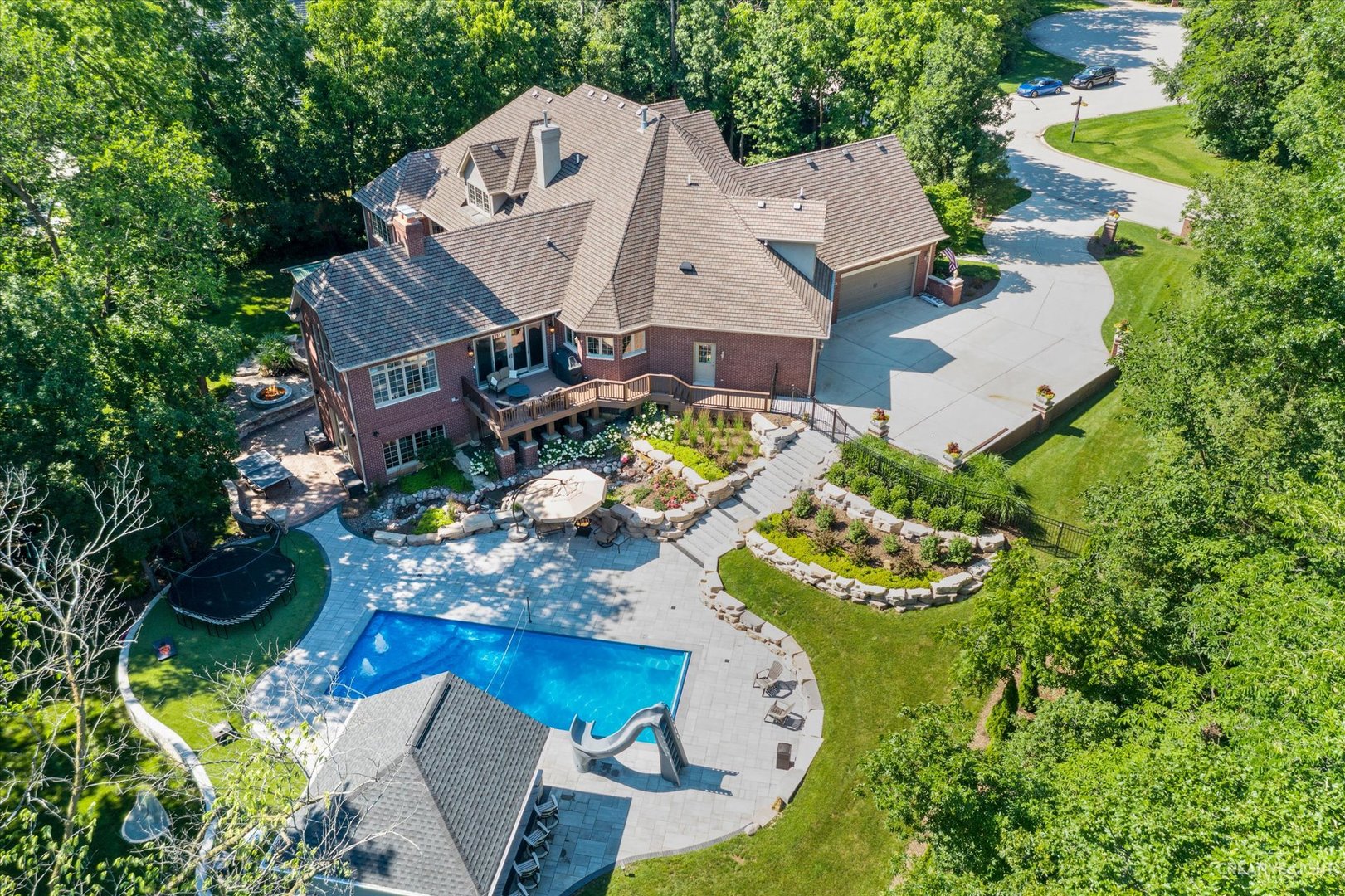 an aerial view of a house with a swimming pool and patio