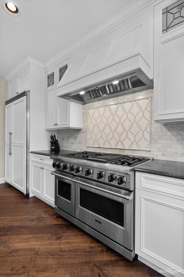 521 Chatfield Road New Lenox, IL 60451 - Photo 17 of 48 a kitchen with a stove and white cabinets