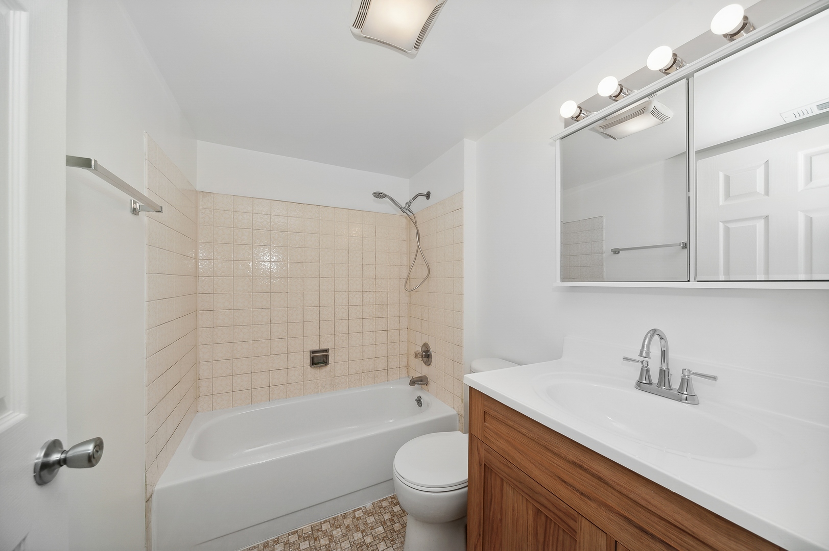 1779 West Algonquin Road, Unit 1A Mount Prospect, IL 60056 - Photo 12 of 15 a bathroom with a sink a toilet and a bathtub