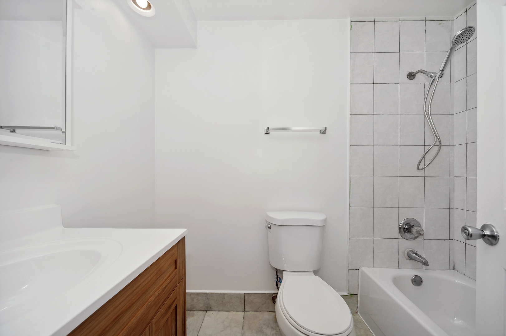 1779 West Algonquin Road, Unit 1A Mount Prospect, IL 60056 - Photo 13 of 15 a bathroom with a sink a toilet and bathtub