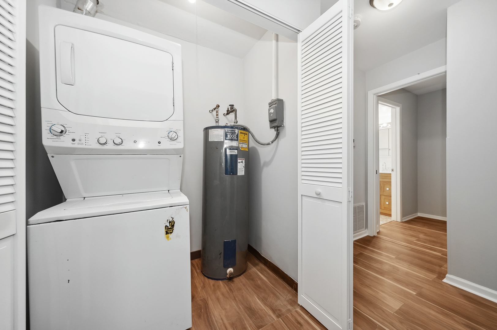 1779 West Algonquin Road, Unit 1A Mount Prospect, IL 60056 - Photo 14 of 15 a view of washer and dryer with wooden floor
