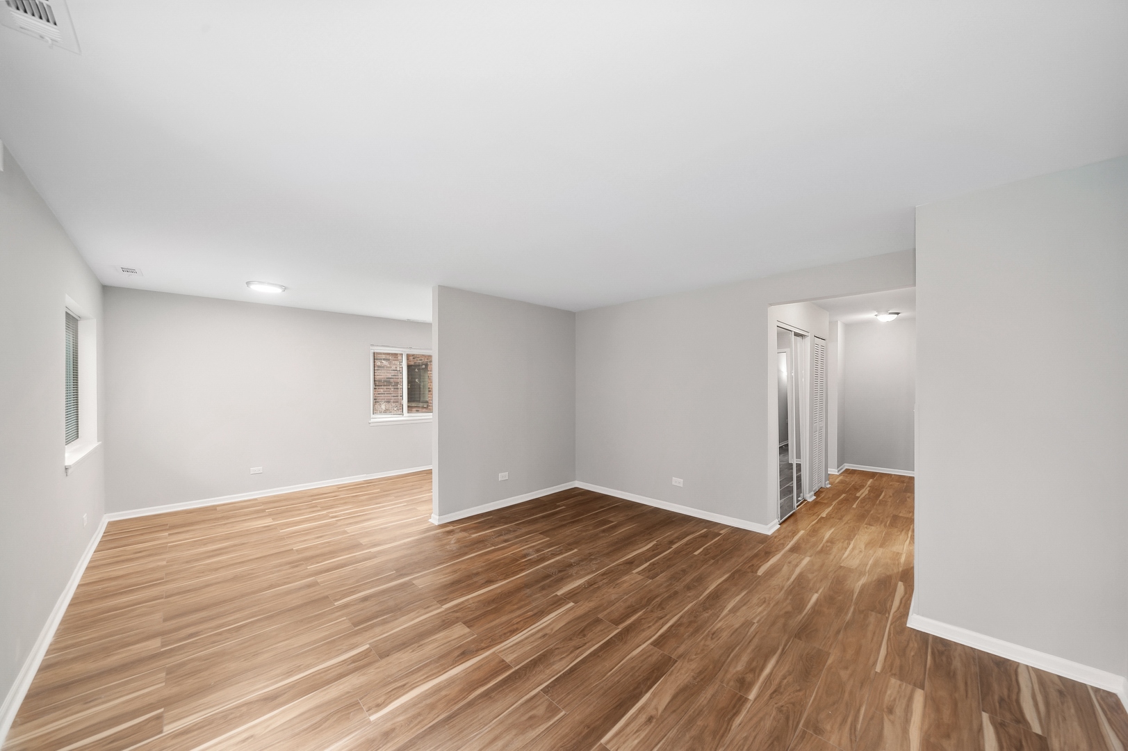 1779 West Algonquin Road, Unit 1A Mount Prospect, IL 60056 - Photo 2 of 15 a view of an empty room with wooden floor