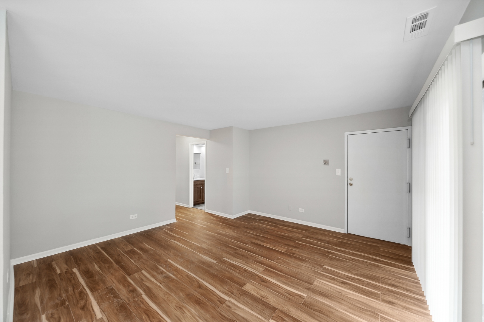 1779 West Algonquin Road, Unit 1A Mount Prospect, IL 60056 - Photo 3 of 15 a view of empty room with wooden floor