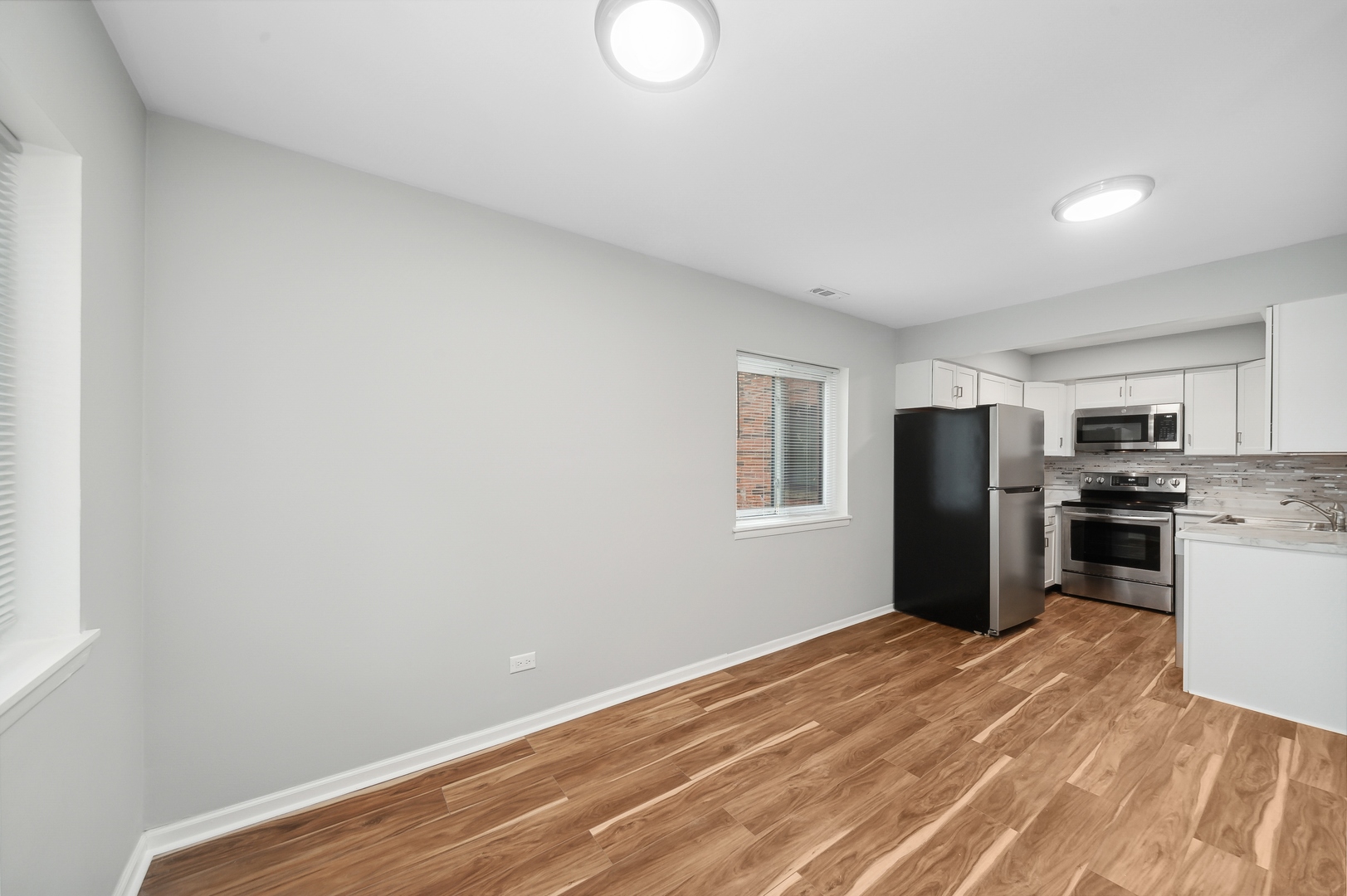 1779 West Algonquin Road, Unit 1A Mount Prospect, IL 60056 - Photo 6 of 15 a view of a kitchen with refrigerator stove and wooden floor