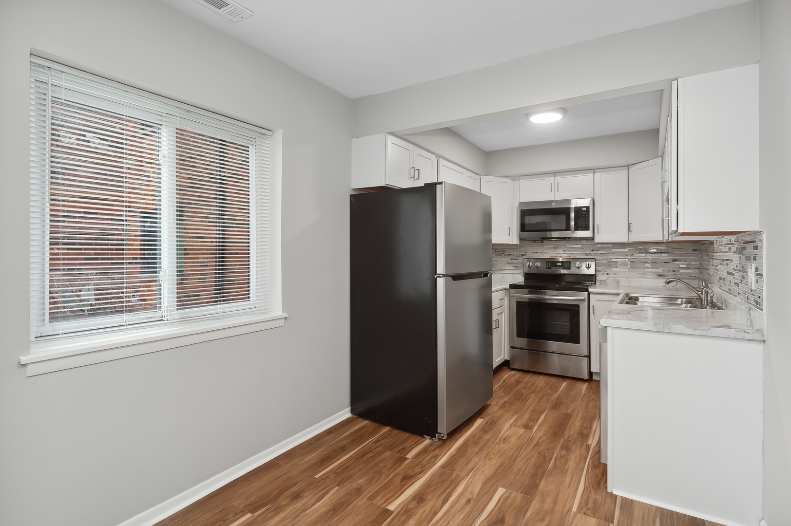 1779 West Algonquin Road, Unit 1A Mount Prospect, IL 60056 - Photo 7 of 15 a kitchen with a refrigerator stove and microwave