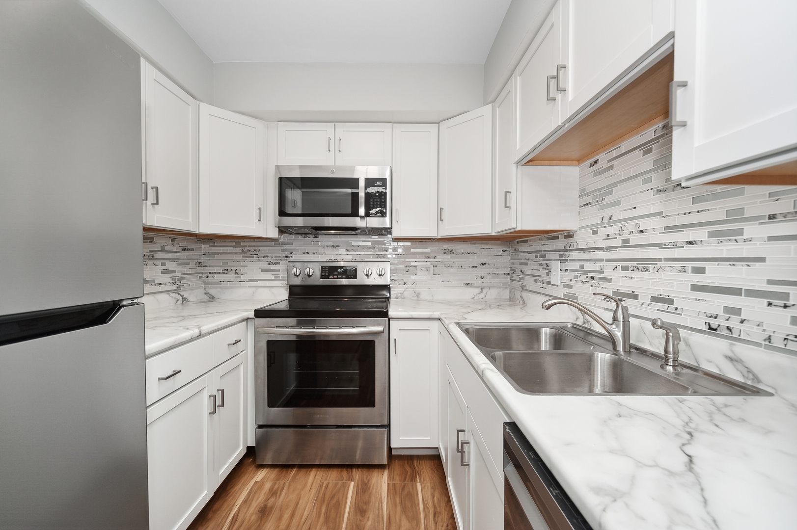 1779 West Algonquin Road, Unit 1A Mount Prospect, IL 60056 - Photo 8 of 15 a kitchen with a sink stove and microwave