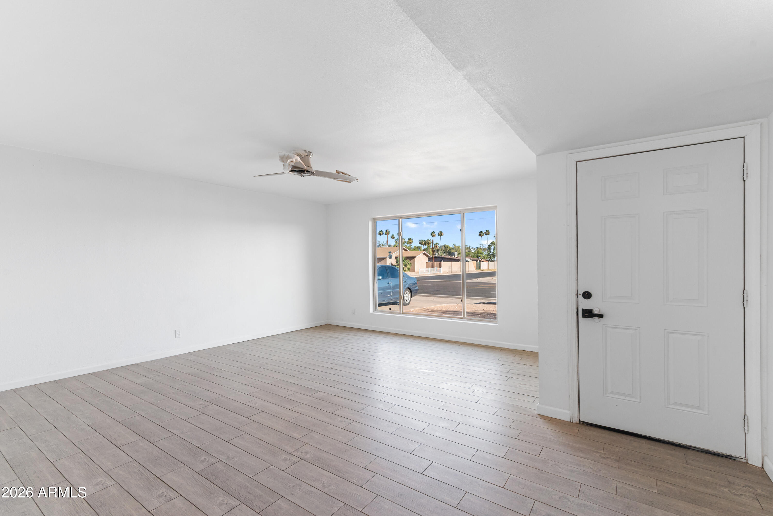 860 West McLellan Road Mesa, AZ 85201 - Photo 11 of 26 an empty room with wooden floor and window