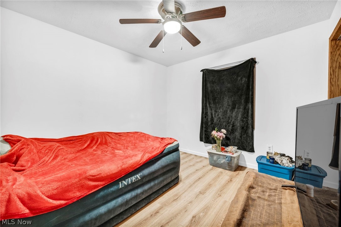 4560 Arrow Road Northwest Carrollton, OH 44615 - Photo 21 of 41 Bedroom with ceiling fan and wood-type flooring