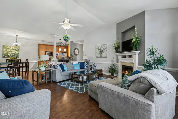 a living room with furniture a fireplace and a flat screen tv