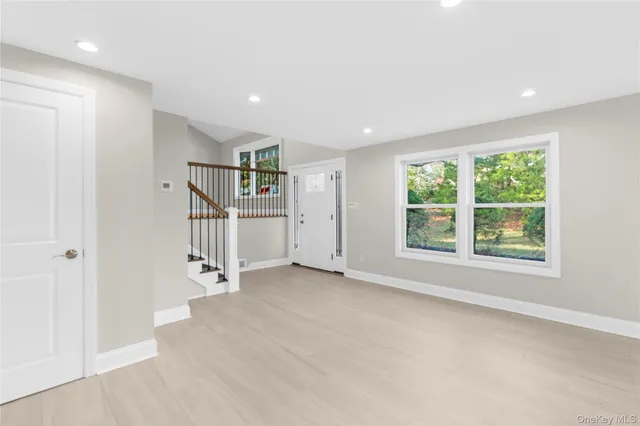 a view of room with window and wooden floor