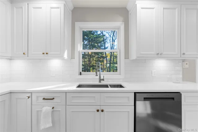 a view of a big room with wooden floor and windows